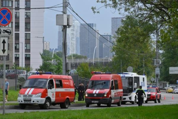 Police and emergency vehicles parked at the side of the wreckage of the drone fell near the Karamyshevskaya embankment to the after a reported drone attack in Moscow, Russia, on Friday, Aug. 11, 2023. The Mayor of Moscow, Sergei Sobyanin said a drone fell in western Moscow after it was shot down by air defense systems. Sobyanin said no-one was hurt when the drone fell near Karamyshevskaya embankment and that no serious damage was caused. Russian social media channels shared videos of what they said was a drone flying low above Moscow and of smoke rising above the Moscow river. (AP Photo)