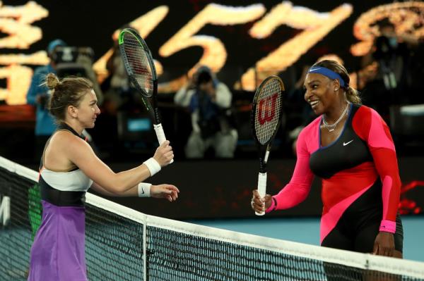 Serena Williams (R) of the US and Romania's Simona Halep touch racquets after their women's singles quarterfinal match at the Australian Open tennis tournament in Melbourne on February 16, 2021.  