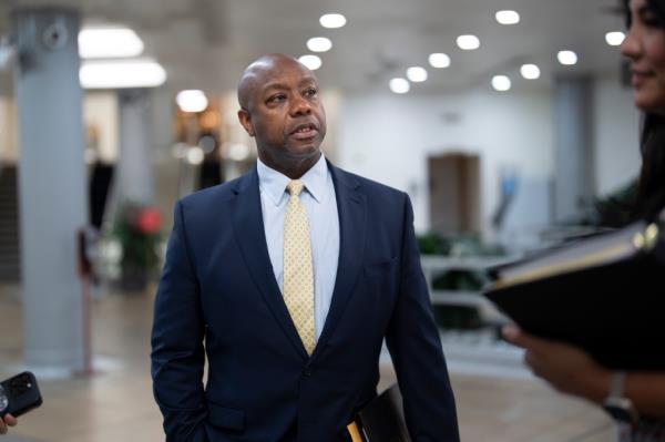 Sen. Tim Scott, R-S.C., who is a GOP candidate for president, speaks with his staff at the Capitol in Washington, Tuesday, June 13, 2023.