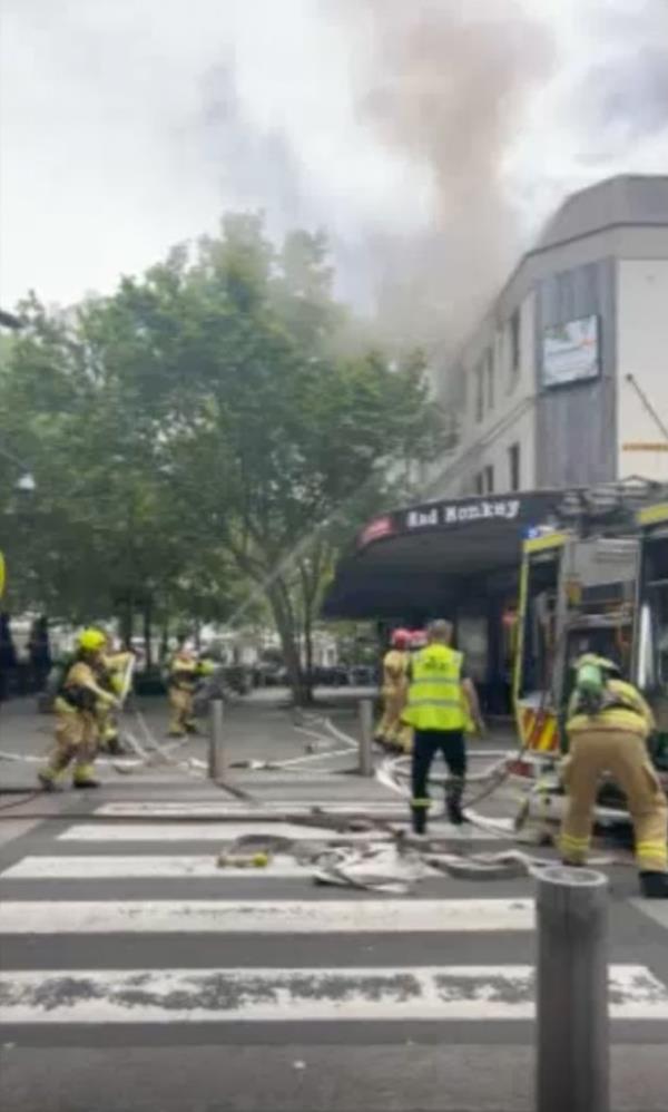Firefighter battle blaze at Australian hostel.