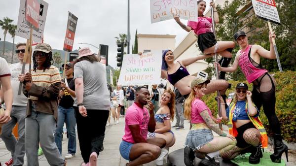Star Garden Topless Dive Bar dancers standing in solidarity with striking WGA writers on the picket line on June 15, 2023 in Burbank, California.