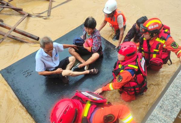 Firefighters evacuate residents stranded by floodwaters after Typhoon Doksuri made landfall in Quanzhou