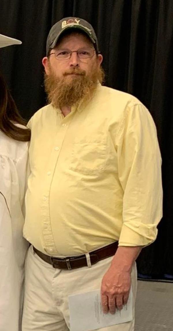 Michael Deslauriers II poses in yellow shirt.