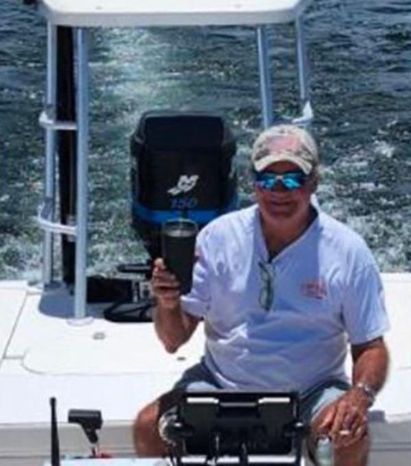 Keith Macneir poses on a boat.