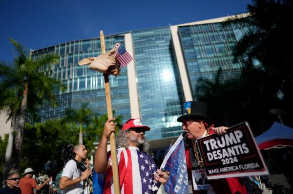 A protestor holds a pig's head impaled on a stick