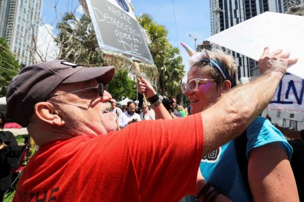 Trump supporters and protesters appearing to shout at each other