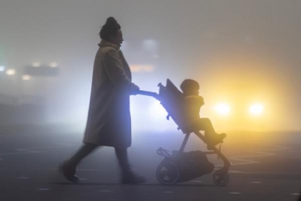  Licensed to Lo<em></em>ndon News Pictures. 23/10/2023. Leeds UK. A woman pushes a buggy through the thick fog this morning in Leeds, Yorkshire, as Storm Babet co<em></em>ntinues to batter the UK. Photo credit: Andrew McCaren/LNP