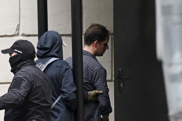 Evan Gershkovich (right) is escorted outside the Lefortovsky Court in Moscow on August 24, 2023.