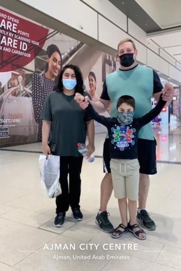 Dobbs is pictured with his wife and one of their sons at the Ajman City Centre in the United Arab Emirates.