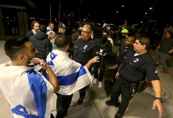 LAPD officers get between supporters of Israel and supporters of Palestine outside The Museum of Tolerance in Los Angeles 