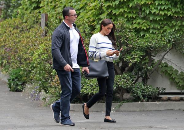 Markle walks alo<em></em>ngside security.
