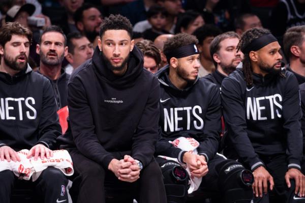 Ben Simmons sits on the bench during a Nets game last season.
