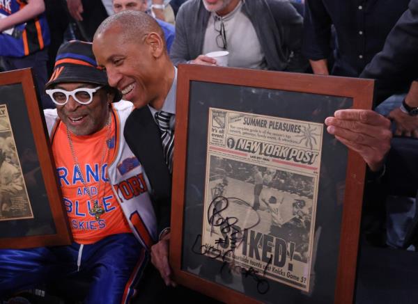Reggie Miller poses for a photo after he autographs two f<em></em>ramed newspapers for Spike Lee one of them is a New York Post before the start of to<em></em>nightas game.