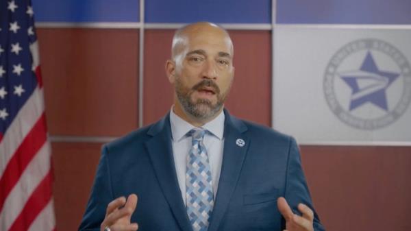 Peter Rendina in a suit, deputy chief inspector for the US Postal Inspection Service seen in a video.
