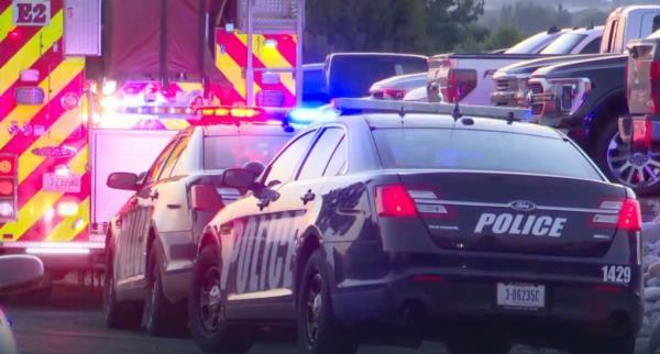 Police and emergency vehicles are seen shutting  down the roads around the country club. 