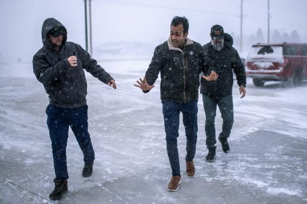 Vivek Ramaswamy steadies himself as he recovers from a slip on the snow to an event ahead of the Iowa caucus vote in Hubbard, Iowa, U.S. January 12, 2024. 