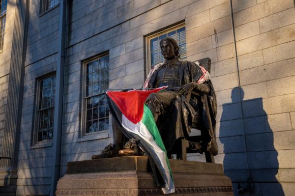 Harvard students draped the statue of John Harvard, the first major benefactor of Harvard College, in Palestinian garb.