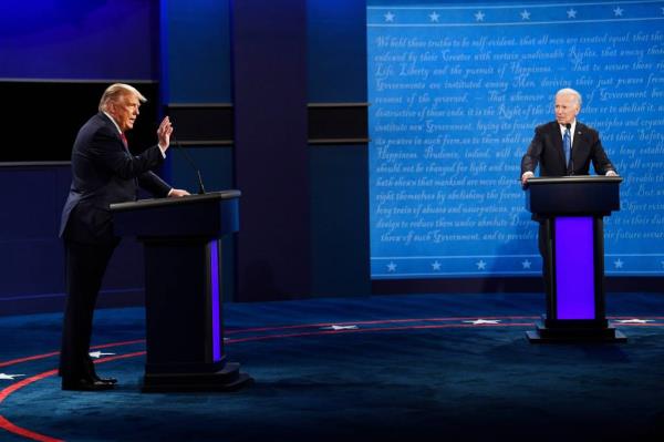 President Do<em></em>nald Trump speaking at a podium with Joe Biden listening during the final presidential debate at Belmont University, Nashville, Tenn., October 22, 2020.