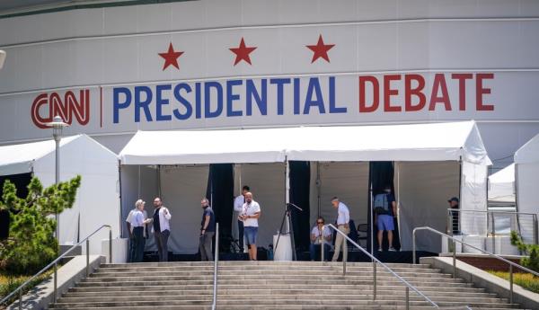 Exterior view of Georgia Tech's McCamish Pavilion the day before a presidential debate, with a group of people standing on stairs