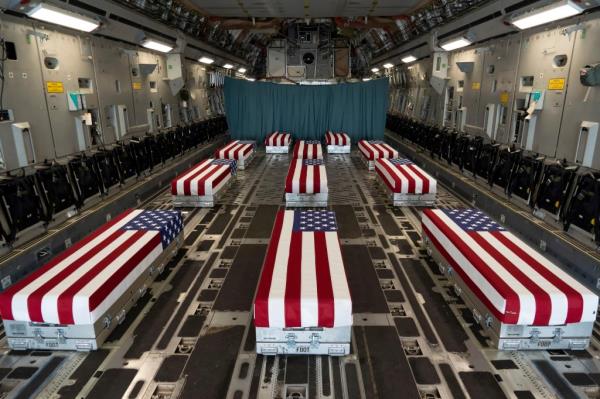 Flag-draped transfer cases of U.S. military service members who were killed by an August 26 suicide bombing at Kabul's Hamid Karzai Internatio<em></em>nal Airport line the inside of a C-17 Globemaster II prior to a dignified transfer at Dover Air Force ba<em></em>se, Delaware on August 29, 2021.