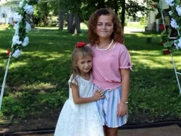 Kyriana and Kelsey Couture, standing together in a park.