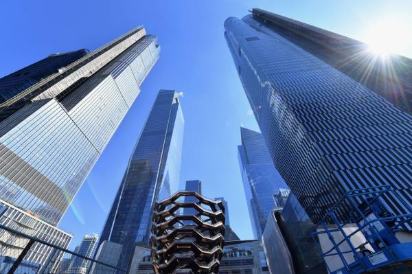 Hudson Yards view looking up, high rises at either end with the Vessel in the center.