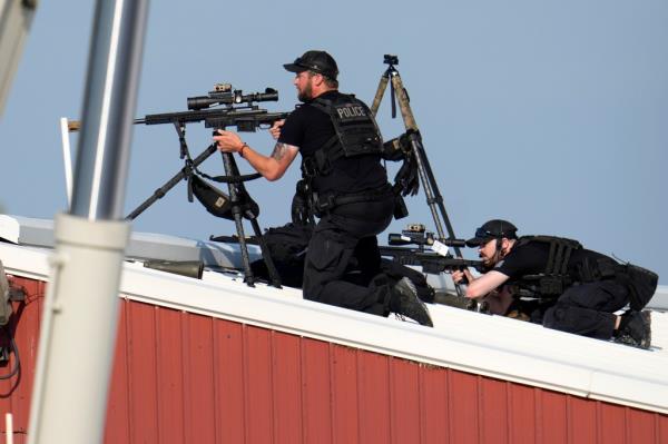 Police snipers return fire after shots were fired while Republican presidential candidate former President Do<em></em>nald Trump was speaking at a campaign event in Butler, Pa., on Saturday, July 13, 2024.