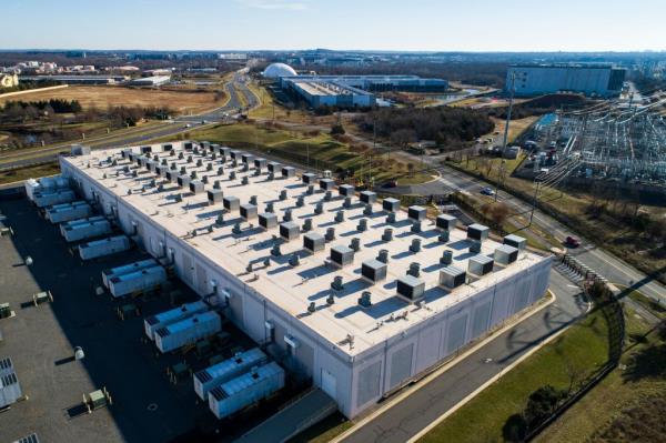 Drone view of Amazon Web Services (AWS) data center with ventilation fans in Ashburn, Virginia