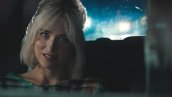 Dakota Johnson smiling in a car during a late-night drive, a still from 