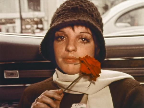 Liza Minnelli wearing a hat and holding a rose in 'LIZA: A Truly Terrific Absolutely True Story' docu<em></em>mentary
