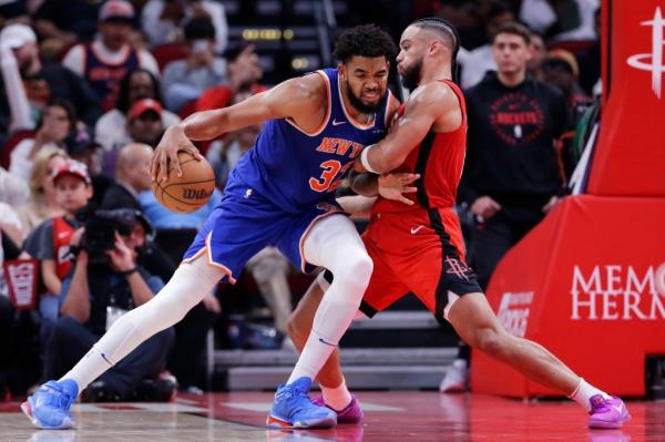 Knicks center Karl-Anthony Towns, left, drives into Houston Rockets forward Dillon Brooks, right, during the second half of an NBA basketball game Monday, Nov. 4.