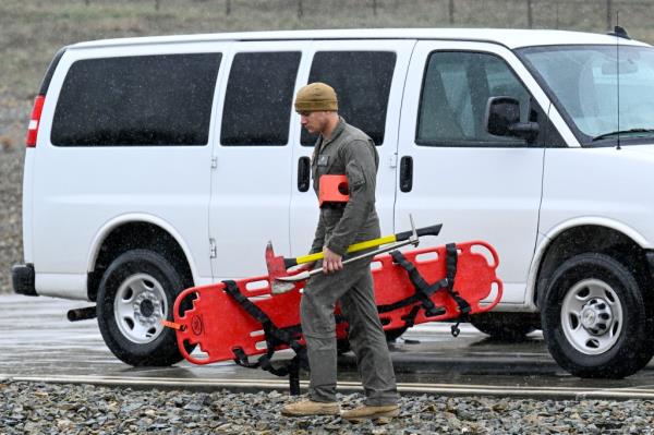 A U.S. Marine carries rescue gear at a command center Wednesday, Feb. 7, 2024, in Kitchen Creek, Calif.
