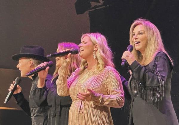 Gospel group The Nelons singing into micropho<em></em>nes at a concert