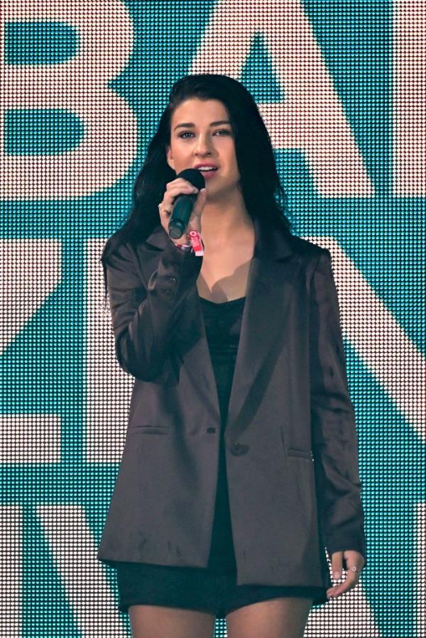 Phoebe Gates holds a microphone at the Global Citizen Festival in Central Park