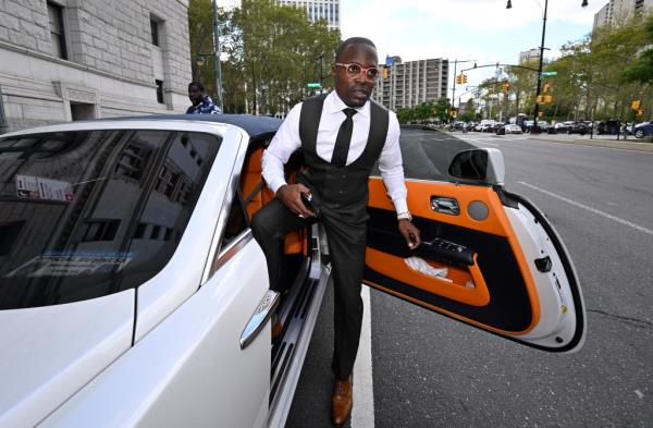 Lamor Whitehead steps into a white Rolls Royce 