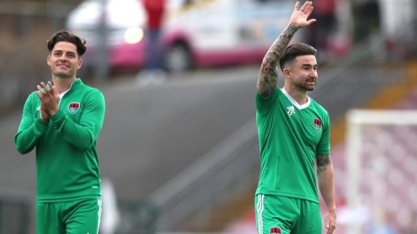 Ruairi Keating (L) and Sean Maguire salute the Turner's Cross crowd