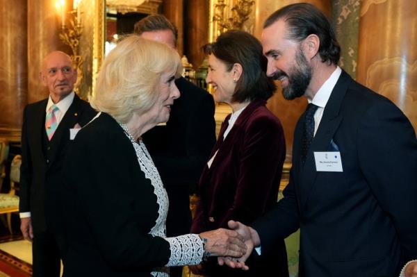 Queen Camilla meets British actor Joseph Fiennes during a reception to celebrate those who work within the TV and film industry, at Buckingham Palace, in central London, on November 13, 2024. 