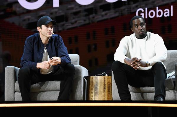 Ashton Kutcher (L) and Sean Combs speaking at an event in 2019.