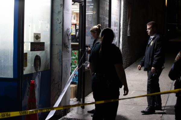 Police are seen at the scene of a fatal stabbing on Queens Blvd. in Queens, Tuesday, May 7, 2024. The stabbing happened in the bodega at 97-02 Queens Blvd. with a blood trail to 97-50 Queens Blvd. wher<em></em>e the victim collapsed.  