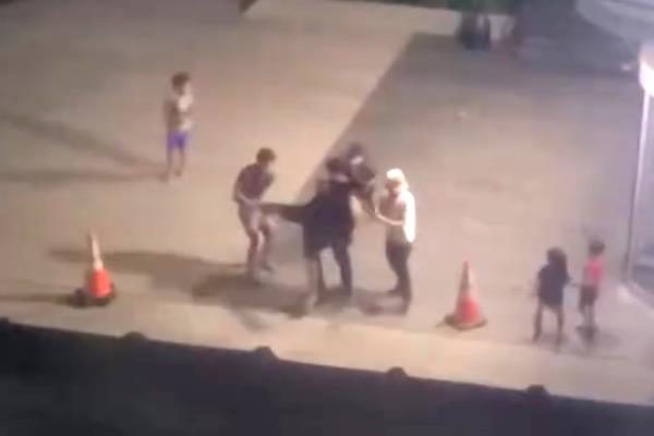 A screenshot from video showing the teens fighting.