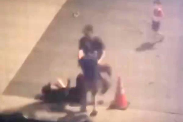 A screenshot from another video showing the teens fighting with one prone on the ground.