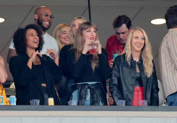 Taylor Swift and Brittany Mahomes (right) in a luxury box during the Kansas City Chiefs vs. New York Jets game, holding drinks in the 2nd quarter.