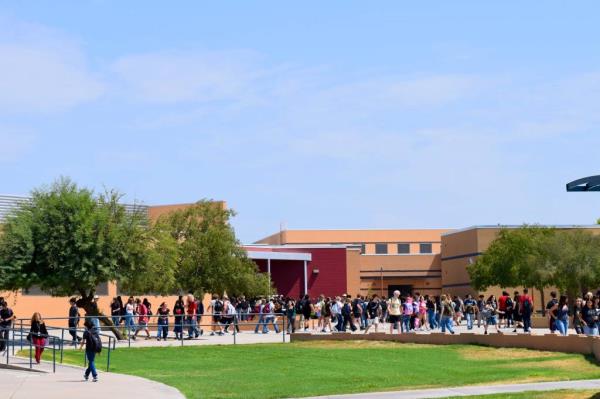 Students walking outside Apache Junction High School during passing period on July 25, 2024