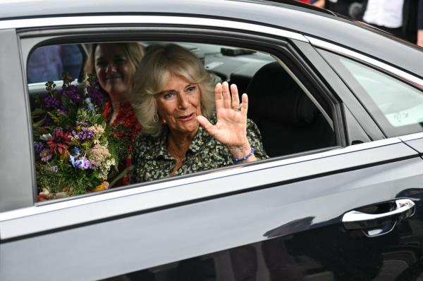 Queen Camilla waving from a car as she leaves the Dyson Cancer Centre, Bath, England in September 2024, before postpo<em></em>ning engagements due to a chest infection.