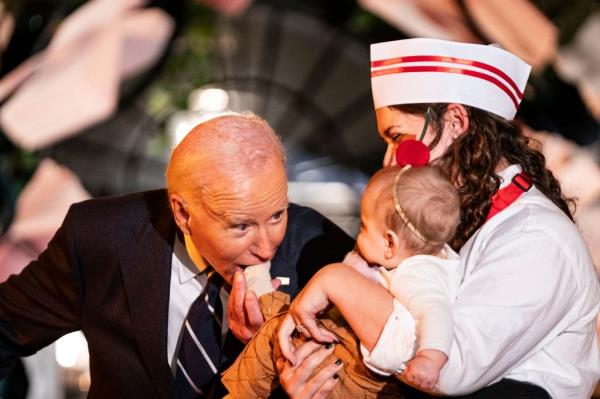 President Joe Biden and First Lady Jill Biden hand out candy and books to trick-or-treaters on the South Lawn of the White House in Washington, DC on Wednesday, October 29, 2024.