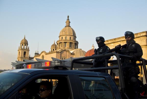 Mexican federal police patrol a street near the City Hall building in Toluca, Mexico, on February 18, 2014. 
