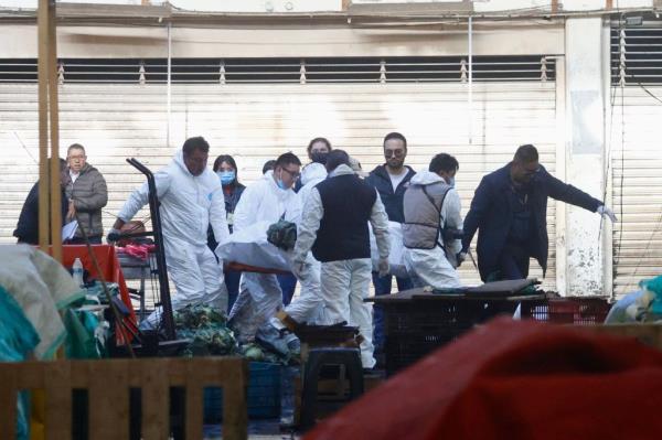 Forensic experts work at the site after a fire broke out in the Central de Abasto of Toluca, in Toluca, State of Mexico, Mexico, 10 July 2023.