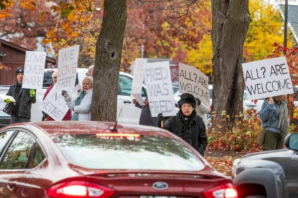 on Oct. 27, supporters of the lo<em></em>ngtime music director picketed outside the church in protest before carrying signs reading: “Love Not Hate,” “God Includes, Not Excludes,” and “Fired Not Retired.”