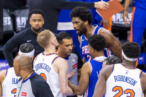 Do<em></em>nte DiVincenzo of the New York Knicks and Joel Embiid of the Philadelphia 76ers engaged in co<em></em>nversation during a basketball game