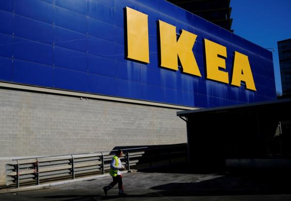 Worker walks past IKEA store.